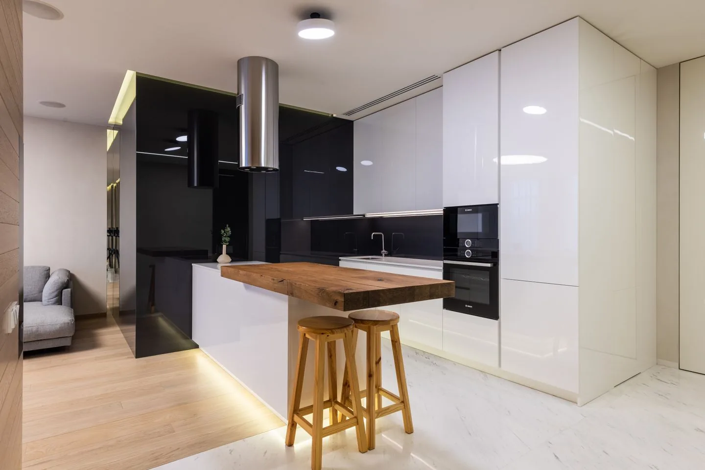 New fitted kitchen in Leeds with taupe shaker cabinets, a white island and built-in wine cooler