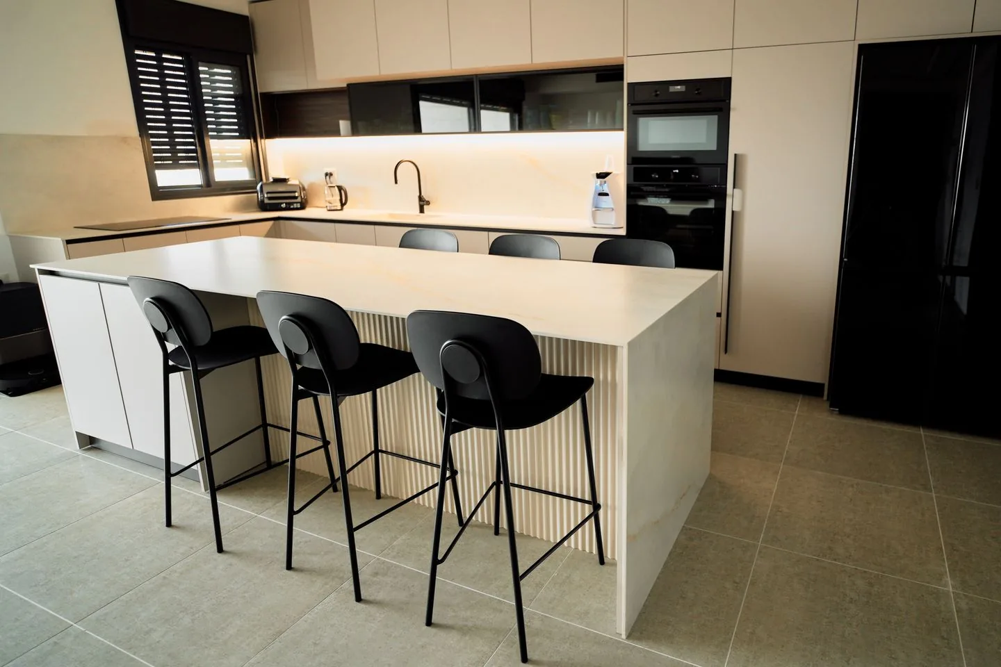 Quality kitchen installation in Bradford with white shaker cabinets and black worktops
