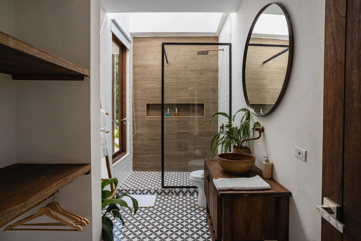 Modern bathroom installation in West Yorkshire with a walk-in shower, backlit mirror and wall-hung vanity